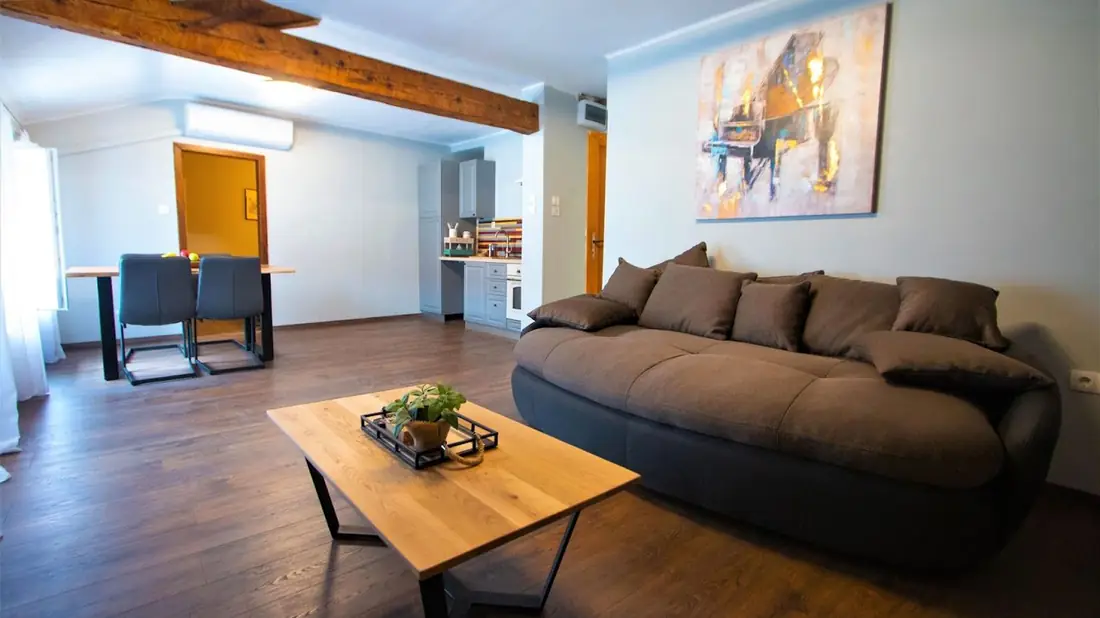 Living room with sofa, dining table and kitchen